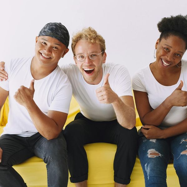 Diverse group of people smiling in a bright studio.