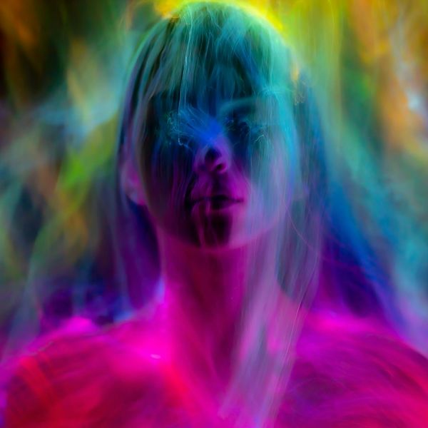 Neon outline of a person meditating with energy flows.